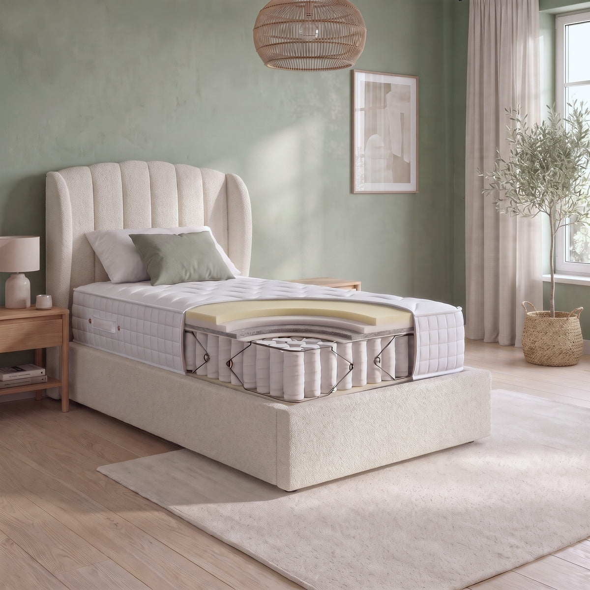 Origins Lux single hybrid mattress cutaway showing memory foam and comfort layers above pocket springs in a bright modern bedroom